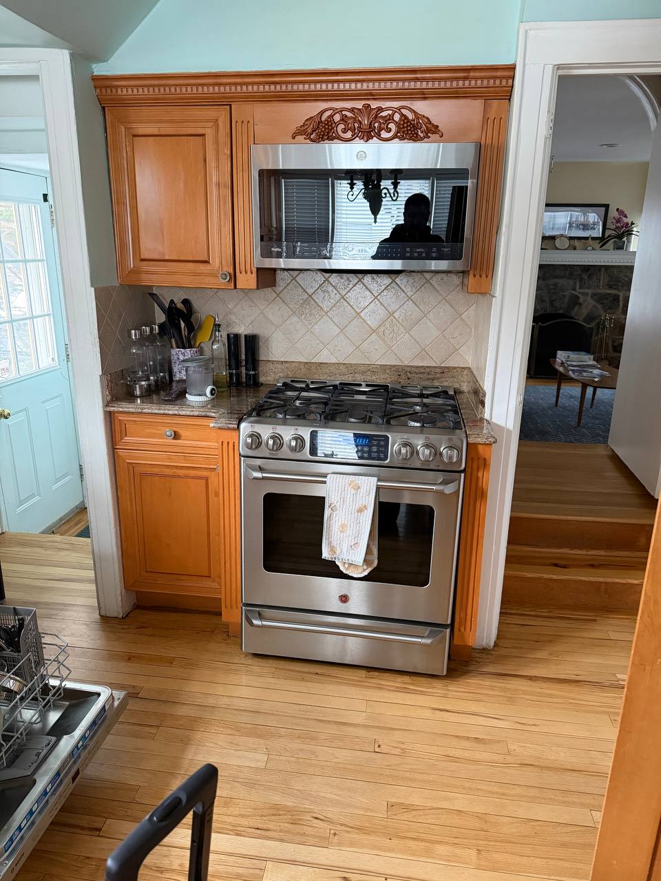 Residential kitchen with gas range and microwave in a New York City brownstone during an appliance service visit